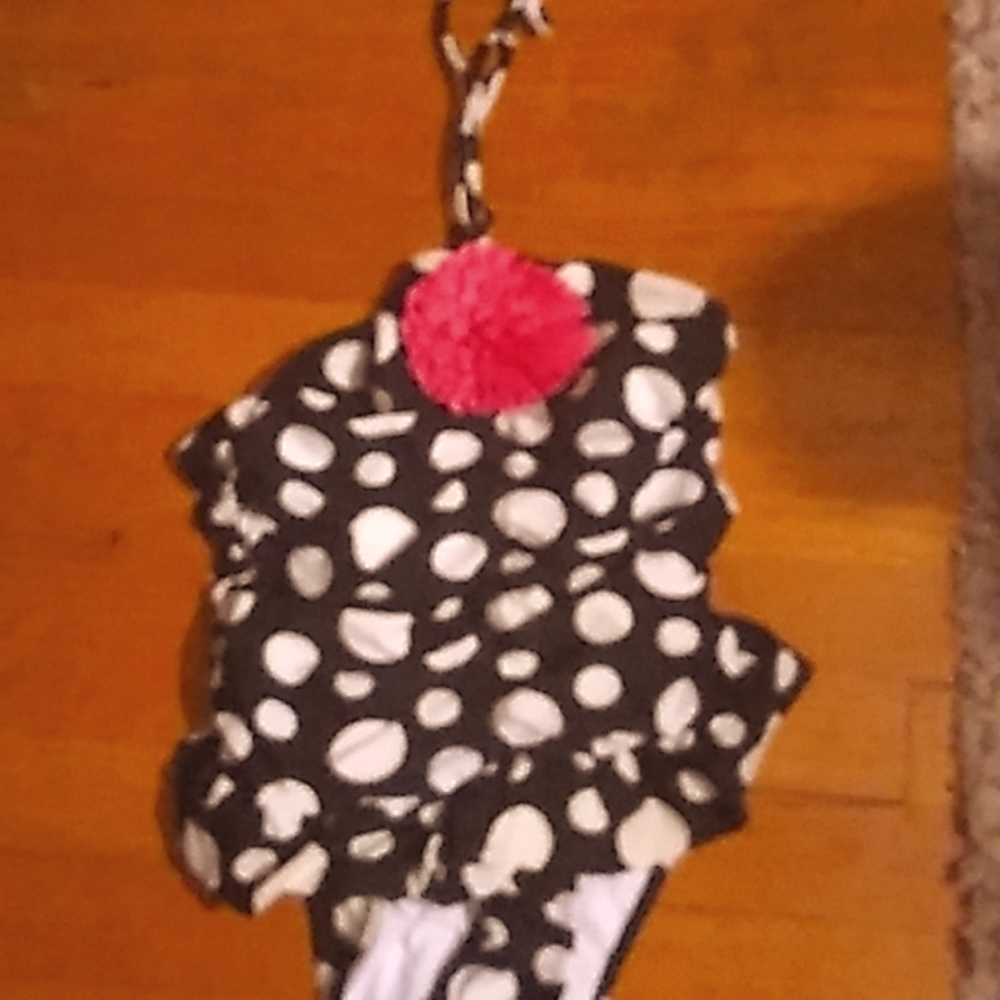 Polkadot child's swimsuit with flower on the top